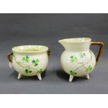 Belleek 'Shamrock' pattered porcelain to include a cauldron and a cream jug, tallest 8cm, (2)