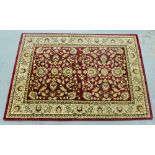 Contemporary woollen rug, the red field with allover foliate pattern, 120 x 179cm