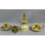 Brass wares to include an engraved candle holder, two chamber sticks and a brass cube, tallest 19cm,