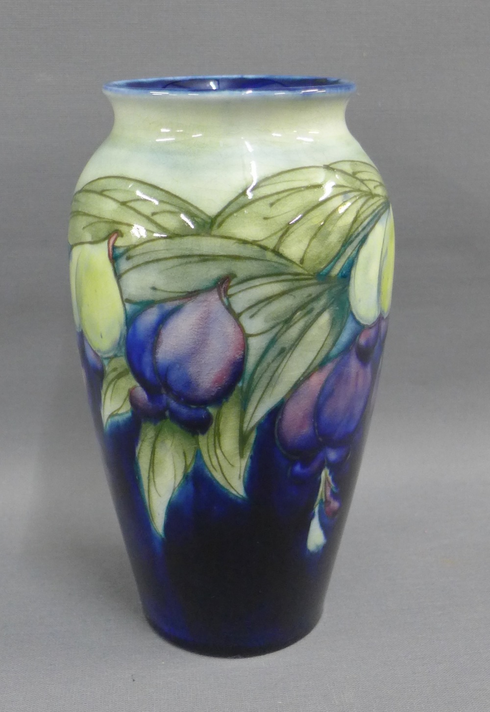 Moorcroft baluster vase with cobalt blue ground and floral pattern, with facsimile signature and