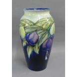 Moorcroft baluster vase with cobalt blue ground and floral pattern, with facsimile signature and