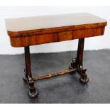 Regency rosewood foldover card table, with a green baize interior on scrolled side supports with