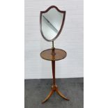 Edwardian mahogany shield shaped mirror on stand with triple splayed feet, 158 x 40cm