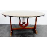 Arts & Crafts walnut and elm centre table, the oval top with studded edge, on a lyre base, 72 x