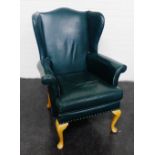 Green vinyl wing back armchair on cabriole legs, 105 x 76cm