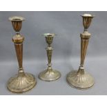 An Adams style candlestick, together with a pair of old Sheffield plate candlesticks, tallest