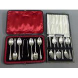 A cased set of six London silver teaspoons and sugar tongs together with a cased set of six