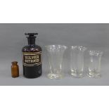 Vintage silver nitrate brown glass bottle and cover together with three various glass measures etc.,
