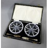 A pair of cut glass butter dishes with Birmingham silver butter knives, in a fitted case