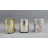 Three 19th century French silver beakers to include a silver gilt beaker with vine and palmette