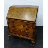 Burr walnut bureau, the fall front opening to reveal a fitted interior above pull out slides and