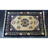 Chinese wool rug, with ivory field and blue borders and central medallion, 190 x 125cm