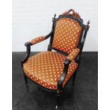 Ebonised open armchair with crested laurel leaf to the top rail, with upholstered back, seat and