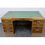 Early 20th century desk, the rectangular top with moulded edge and green skivver, over an