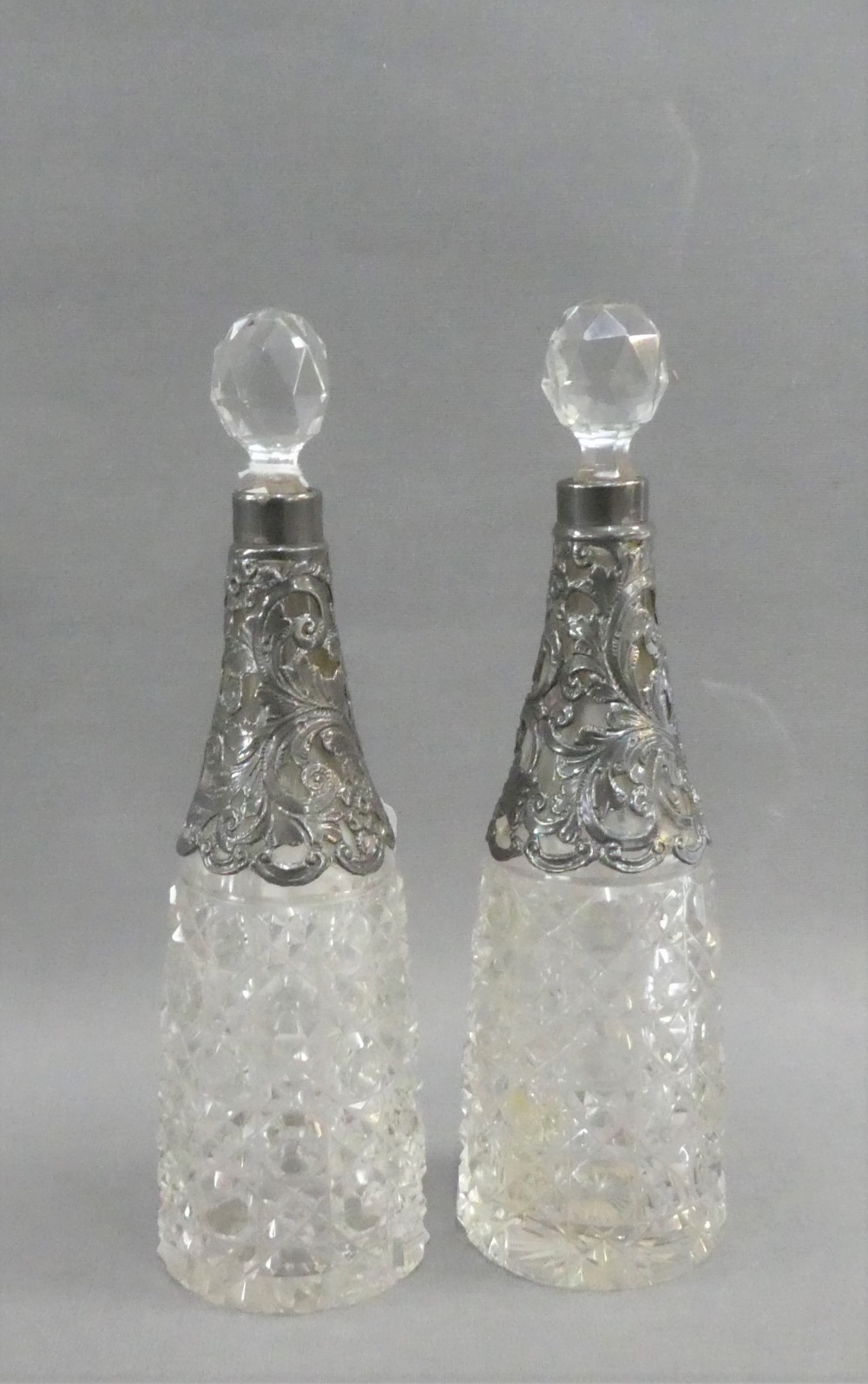 A pair of Victorian silver mounted and cut glass decanters, with stoppers, Birmingham 1897, 21.5cm