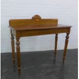 Mahogany side / hall table, the ledge back with a shield motif, raised on turned tapering legs