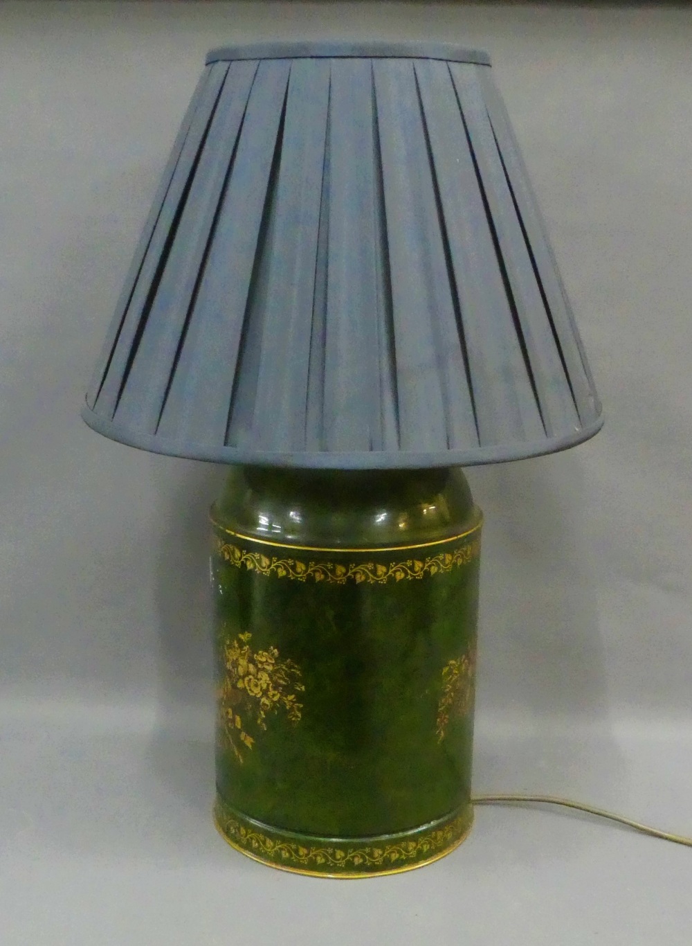 Green painted toile ware style table lamp base, complete with shade, size excluding fitting is