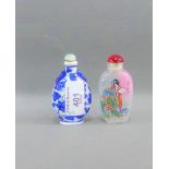 Two snuff bottles, to include a blue and white porcelain example and another painted glass, both