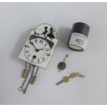 Miniature white enamelled clock face, complete with pendulum and key, 8cm