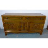 Oak Art Nouveau sideboard with two short drawers above three cupboard doors, with brass handles