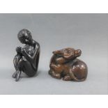 Two Japanese dark wood Netsuke's to include a Naked Lady and another of a Bull, (2)