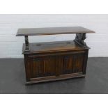 Early 20th century oak Monks bench, the rectangular top on lion arm rests with lift up compartment