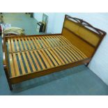 Hardwood Art Nouveau style double bed with canework headboard, 120 x 162cm