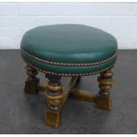 Oak framed footstool with circular green vinyl upholstered top, 28 x 38 cm