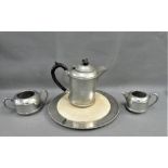 Hammered pewter three piece tea set, comprising teapot, milk jug, sugar bowl and an Epns bread board