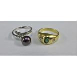 14 carat gold emerald and diamond ring and a silver dress ring (2)