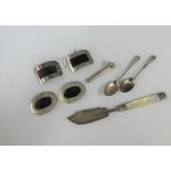 Mixed lot to include a Georgian silver and mother of pearl handled butter knife, silver buckles