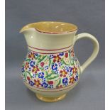 Nicholas Mosse pottery jug with a frieze of coloured flowers to the body, with red rim border,