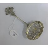 Continental silver spoon with spiral stem and flattened bowl and pierced terminal, 23cm long