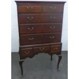 Mahogany chest on stand with rectangular moulded top over two short and three long drawers, with