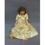 German bisque head doll with brown sleeping eyes, painted mouth, brown hair, jointed limbs and