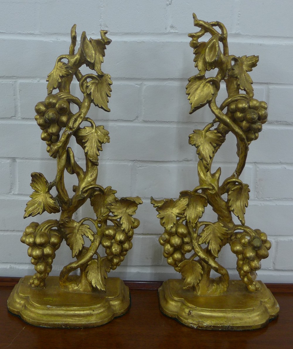 Pair of giltwood wall brackets with grape vine supports and semi circular shelf lined baize, 52cm