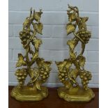 Pair of giltwood wall brackets with grape vine supports and semi circular shelf lined baize, 52cm