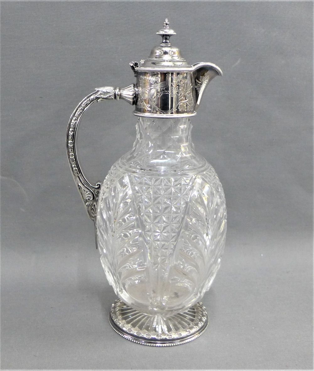 Epns mounted cut glass claret jug, with circular star cut base, 28cm high