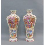 Pair of Chinese high shouldered vases painted with famille rose enamels with figural panels to a