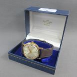 Gents 9 carat gold cased Garrard wristwatch with silvered dial, hour batons and date aperture, on