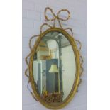 Oval gilt wood mirror with a ribbon motif, 76cm wide