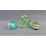 Three paperweights to include a Millefiori paperweight, a Caithness glass 'Cauldron' patterned
