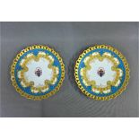 Pair of continental porcelain armorial cabinet plates with reticulated rims, blue scale border and