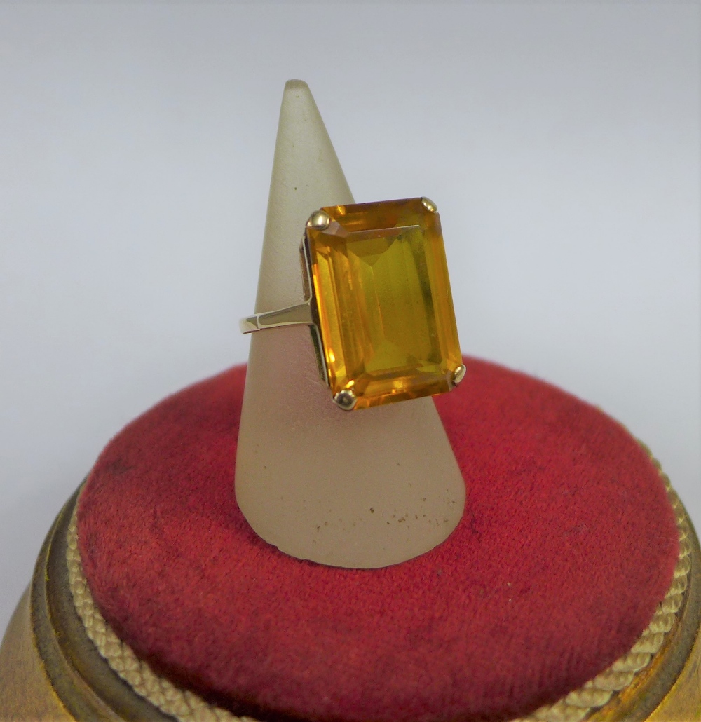 9 carat gold dress ring, claw set with an emerald cut citrine, to a plain gold band, UK ring size R