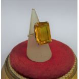 9 carat gold dress ring, claw set with an emerald cut citrine, to a plain gold band, UK ring size R