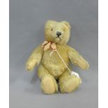 Early 20th century blonde mohair bear with felt pads and jointed limbs, 24cm long