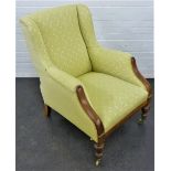 Green floral upholstered armchair on brass mahogany legs with brass castors, 100 x 70cm
