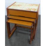 Teak nest of three tables, the top table with tiles and a frieze drawer, 60 x 55cm (3)