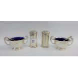 A pair of silver salts, Birmingham 1910, with twin handles and blue glass liners together with a
