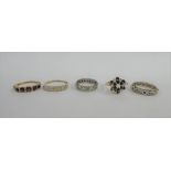 A collection of rings to include three 9 carat gold gemset rings and two eternity rings, one stamped